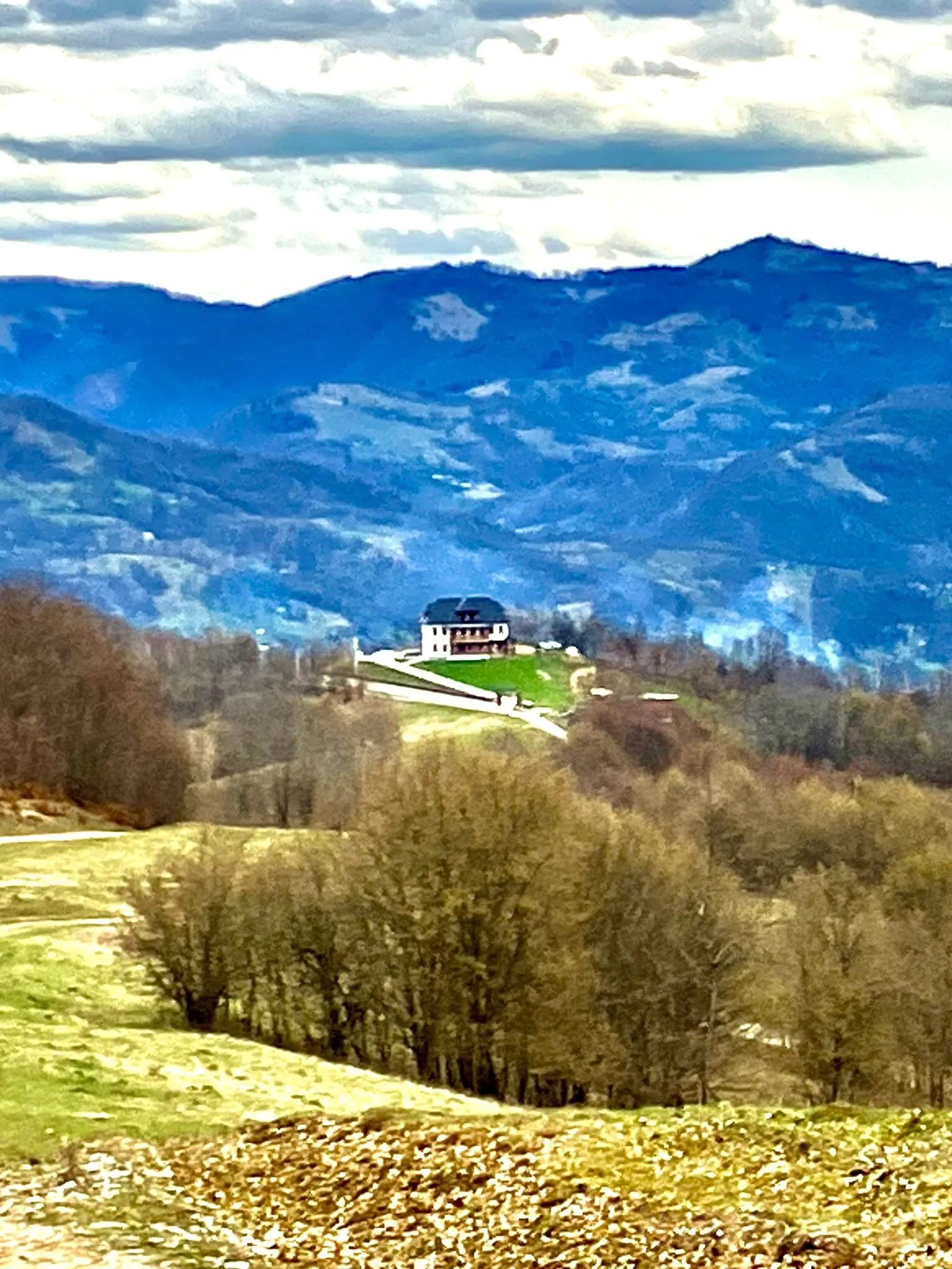 Situare pe varf de deal, langa padure, dar cu acces usor, la 100 m de DN 18, la mijlocul distantei dintre obiectivele turistice