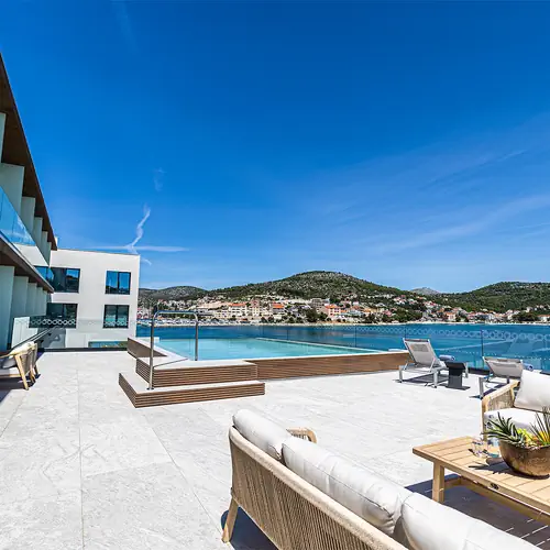 Family Deluxe Rooms have a beautiful view of the sea, and the terrace is equipped with deck chairs and lounge furniture.