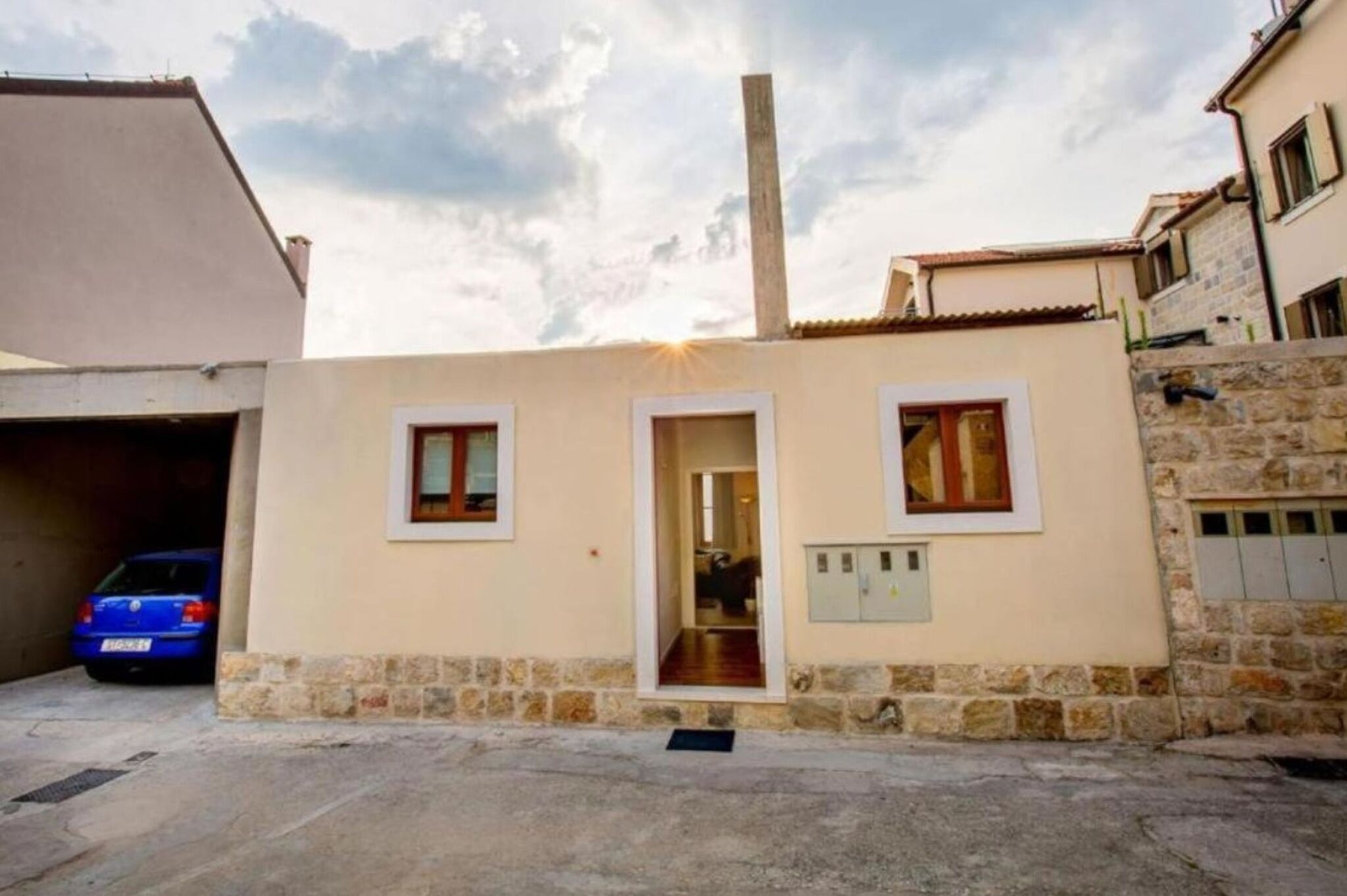 Apartment building entrance and private parking