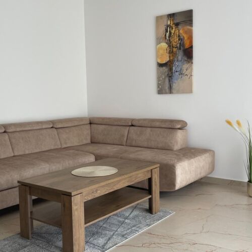 Az apartman nappalijában kényelmes sarok ülőgarnitúra