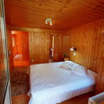 Izba s manželskou posteľou s výhľadom na les na poschodí